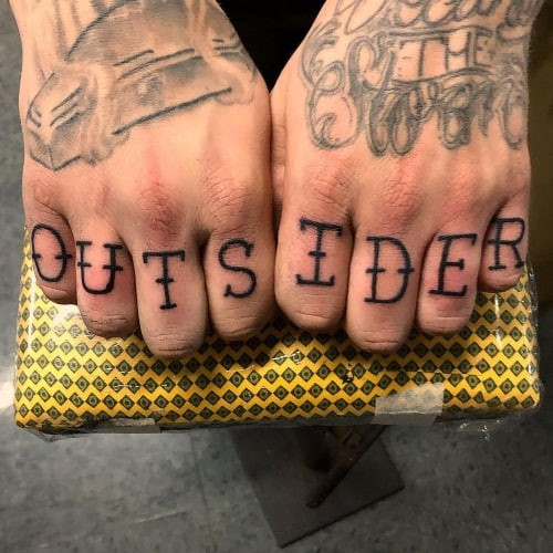 Knuckle tattoos with letters spelling &quot;HOPE&quot; on a man's hands