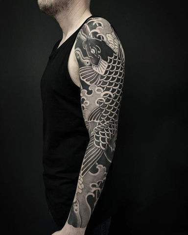 Koi carp fish sleeve tattoo featuring colorful koi fish swimming among water plants and waves