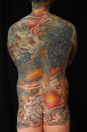 Back view of Kris's impressive tattoo, emphasizing the freehand design and the artist's vision for a seamless bodysuit