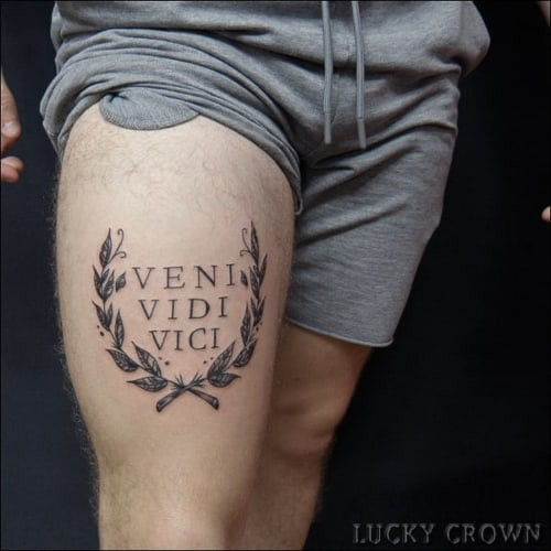 Latin quote tattoo on a man's forearm