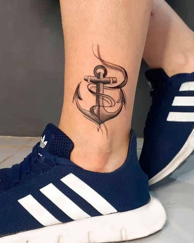 Compass leg tattoo for men representing guidance and direction