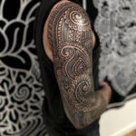 Ornamental blackwork tattoo on arm, showcasing Lenn Black Lotus's signature style.