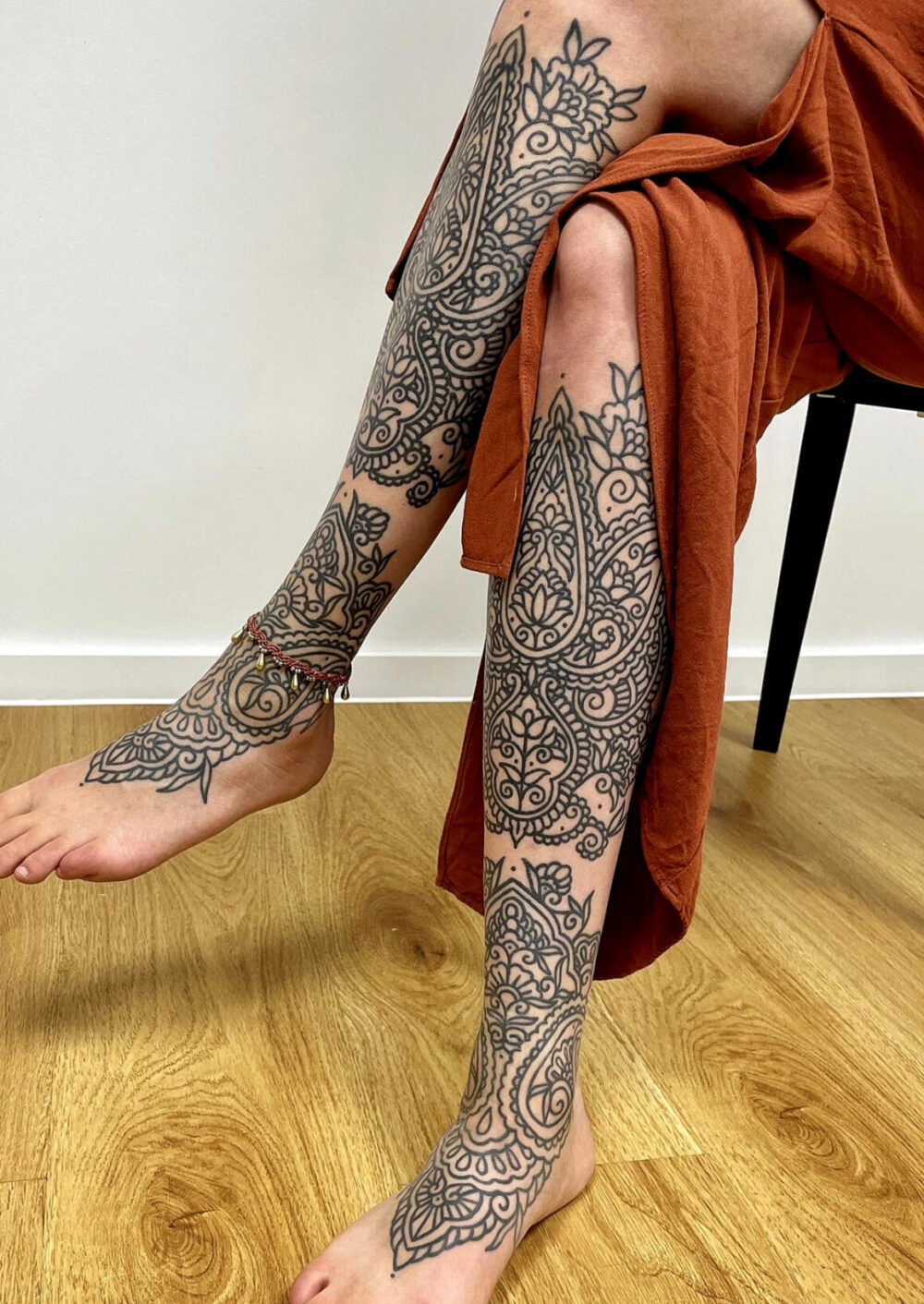 Arm tattoo with geometric and floral ornamental elements by Lenn Black Lotus.