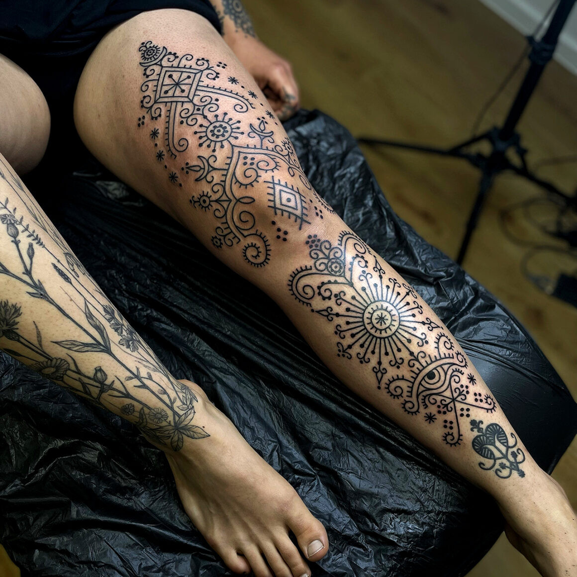 Intricate blackwork tattoo showcasing clean lines and ornamental details by Lenn Black Lotus.