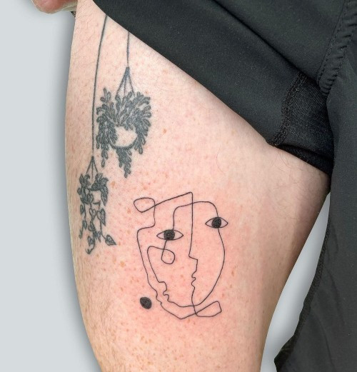 A continuous line drawing tattoo of a flower on a man's hand, delicate and simple