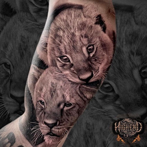 Lion Cub Tattoo, cute and playful, symbolizing youth