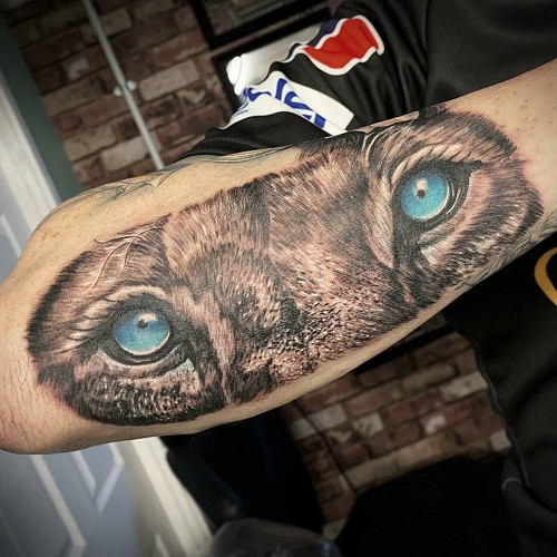 Lion Eyes Tattoo on Back of Neck