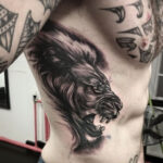 lion face rib tattoo for men