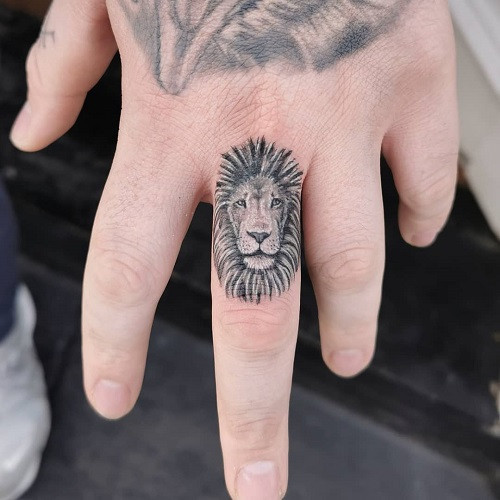 Lion Finger Tattoo, tiny lion tattoo on finger, intricate and miniature