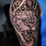 Lion with Crown Tattoo for men, black and grey ink, detailed crown