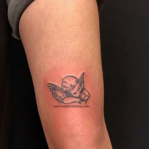 Small and delicate little angel tattoo, suitable for discreet placement and subtle symbolism.