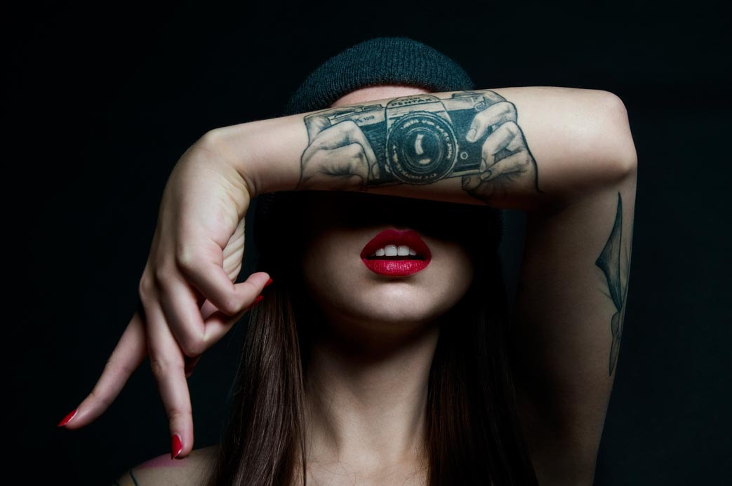 Photographer Lotte van den Acker showcasing her Asahi Pentax camera tattoo