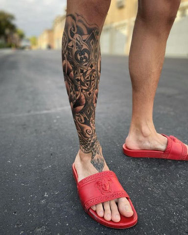 Calf tattoo for men featuring a bold and prominent design