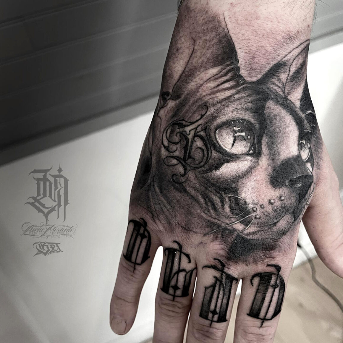 Detailed black and grey Chicano lettering tattoo by Lucho Morante