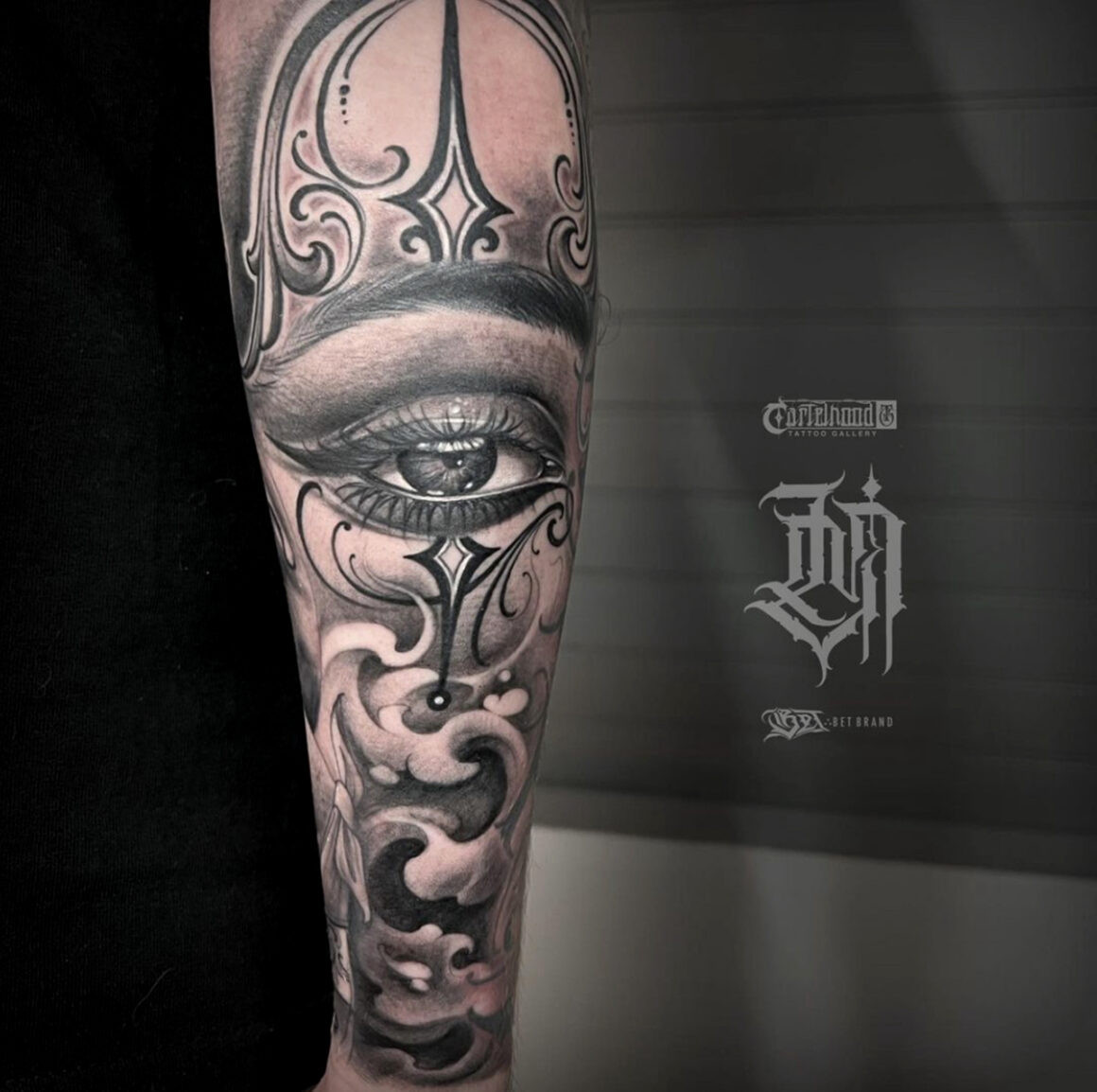 Full sleeve tattoo incorporating various styles including Chicano lettering by Lucho Morante