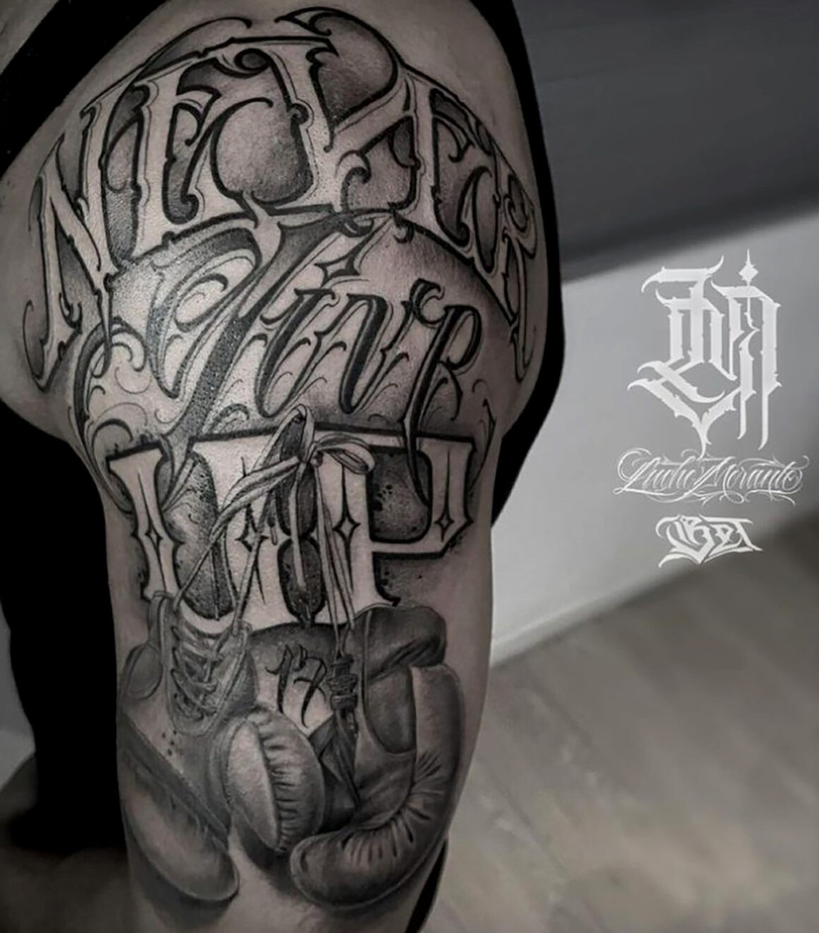 Back piece tattoo featuring Chicano style lettering and religious imagery by Lucho Morante