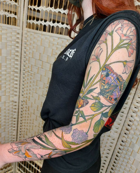 Butterfly sleeve tattoo demonstrating delicate linework and soft shading, a testament to the artist's skill in creating intricate designs.