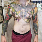 Chest and sleeve tattoos