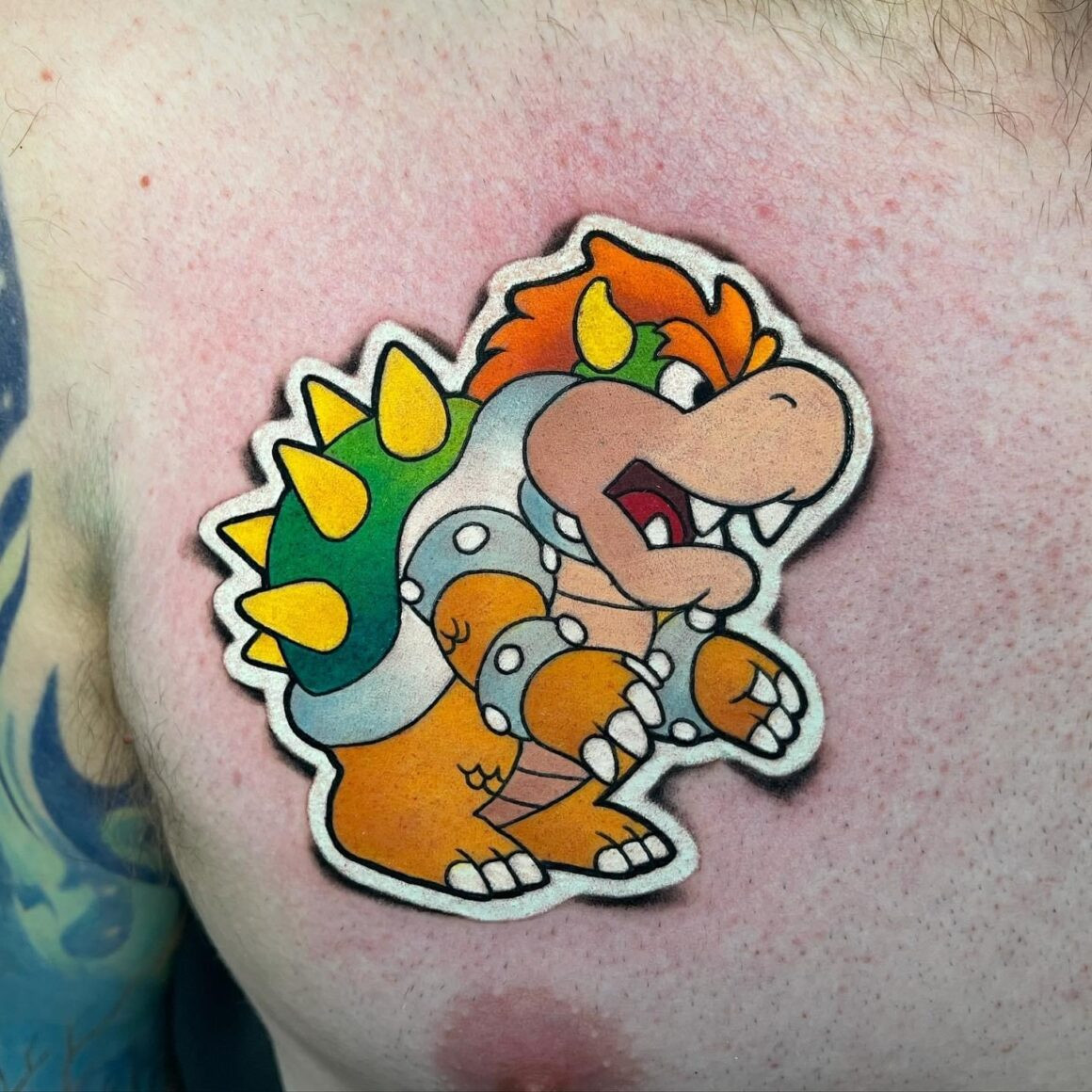 Mr. Sticker posing with a completed tattoo