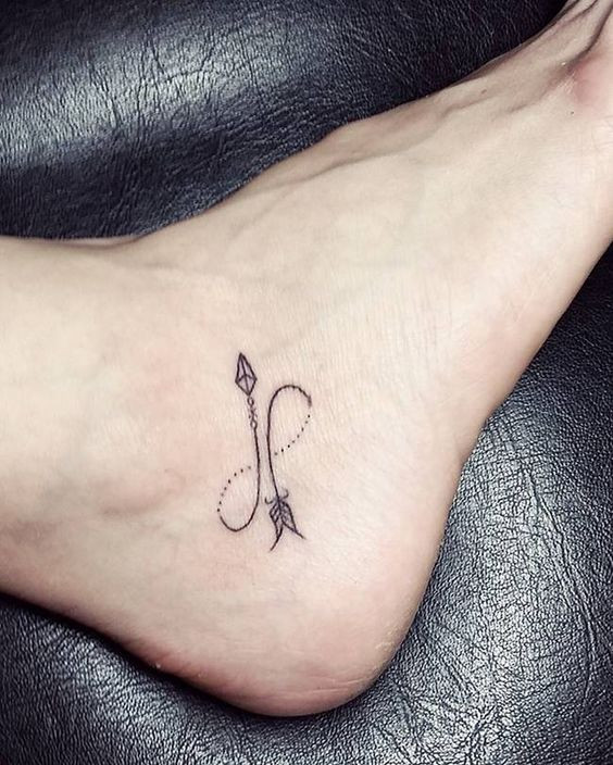 Malin symbol tattoo on forearm, black ink minimalist style.