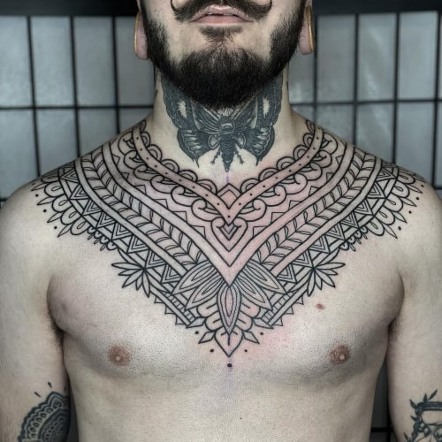 Two mandala tattoos on men, one on the chest with a stylized mandala and lotus flower and another on the shoulder with a geometric mandala pattern.