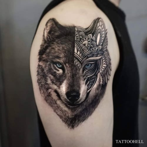 A mandala wolf tattoo on a man's forearm, merging a wolf design with intricate mandala patterns and dot-work, symbolizing a spiritual journey and the wolf as a guide.