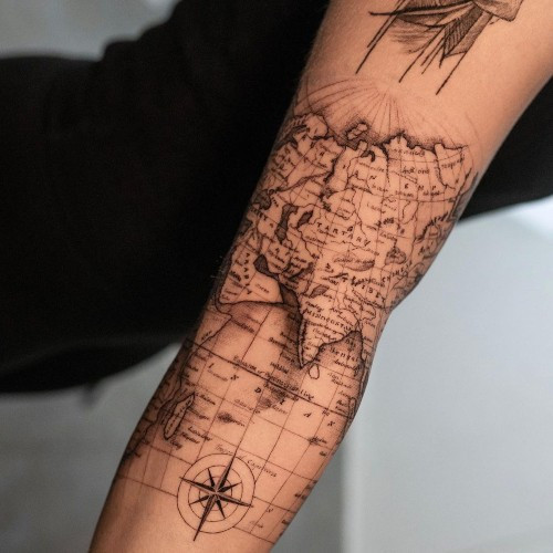 A minimalist map outline tattoo of a city on a man's wrist, subtle place tribute