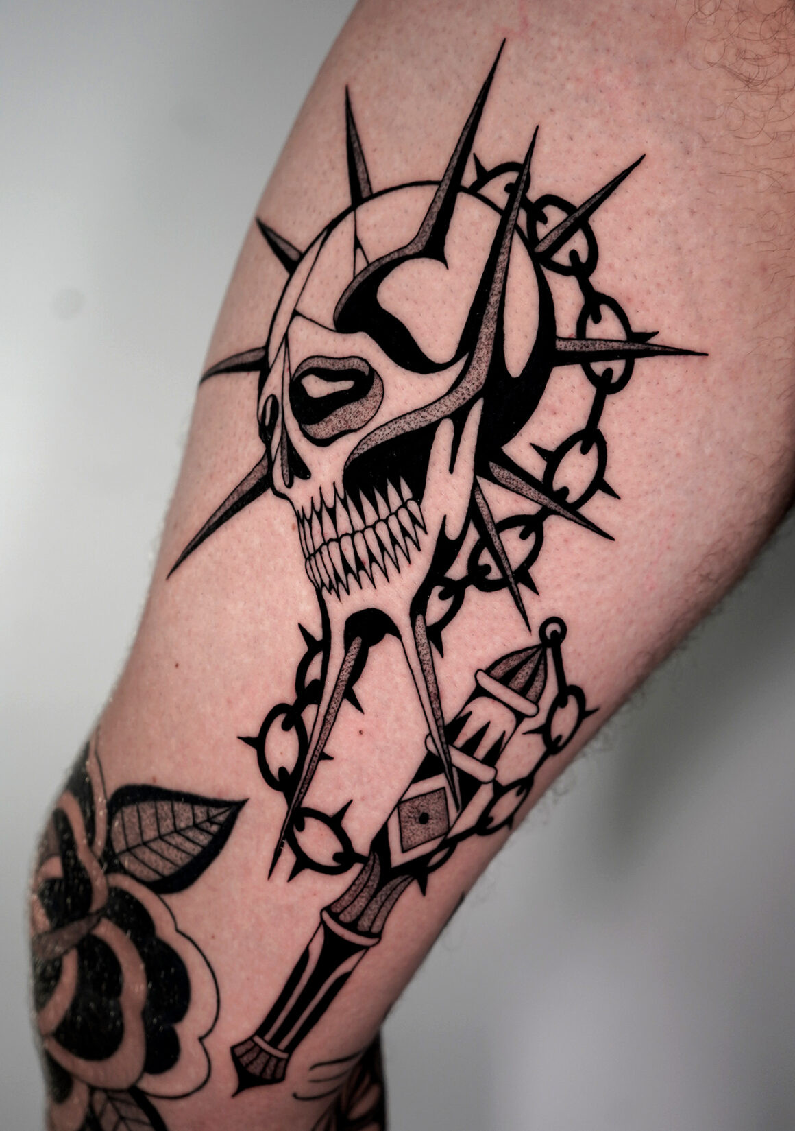 Marco Gruschwitz's surreal blackwork tattoo showcasing intricate details and dark themes.