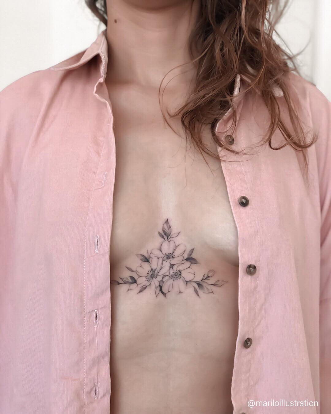 Unique sternum tattoo for women, botanical and leafy design with a central focus point