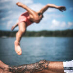 Swimmer with Tattoo Emerging from Pool