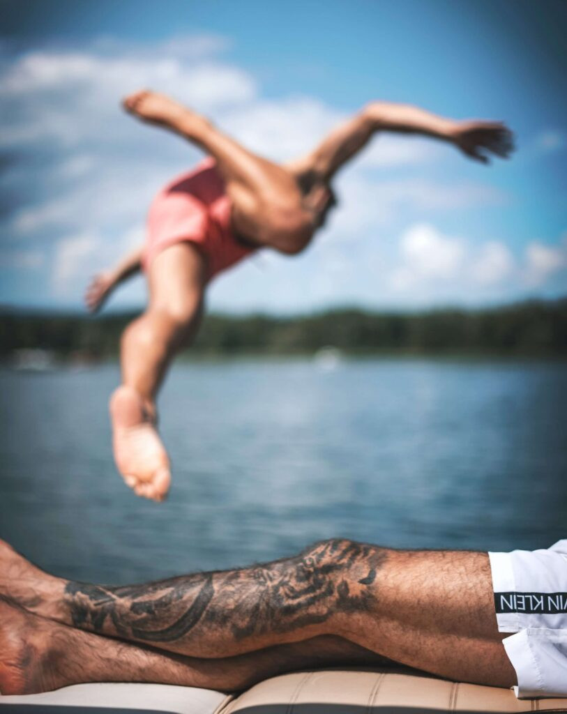 Swimmer with Tattoo Emerging from Pool