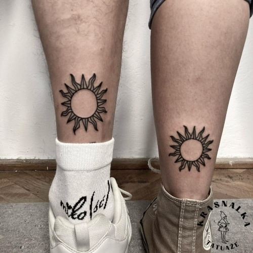 Matching sun and moon tattoos on wrists, symbolizing partnership in men tattoo ideas.