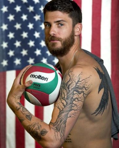 Matt Anderson showcasing his family tree sleeve tattoo on his arm