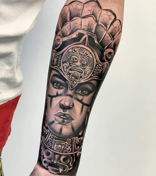 Two mayan tattoos on men, one on the forearm with a Mayan warrior and another on the arm with a Mayan calendar.