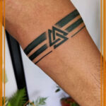 Diverse range of mens wrist tattoo designs including minimalist, tribal, quote, and symbolic styles.