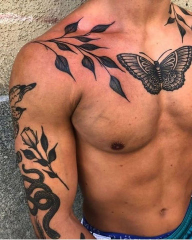 A tribal pattern tattoo extending across a man's chest and shoulder