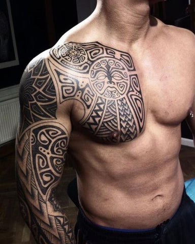 A large dragon tattoo extending from a man's chest onto his shoulder