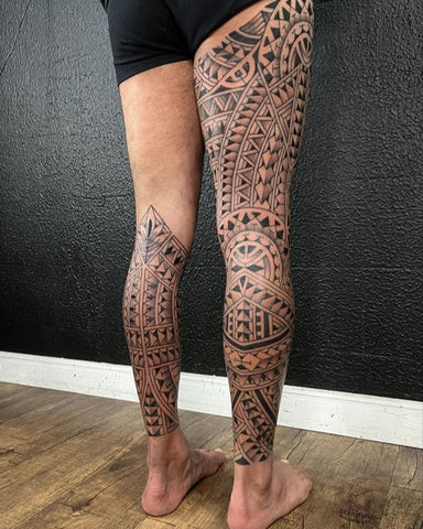 Full leg sleeve tattoo for men showcasing a bold and artistic design