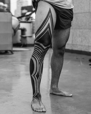 Polynesian tribal leg tattoo for men with powerful geometric patterns