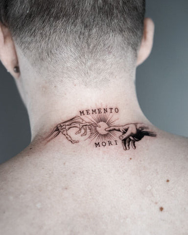 A man displaying a minimalist line art back of neck tattoo, highlighting simplicity and understated style.