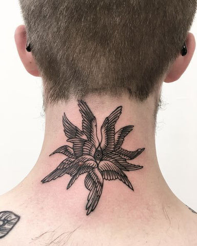 Back of neck tattoo for men featuring a tribal design