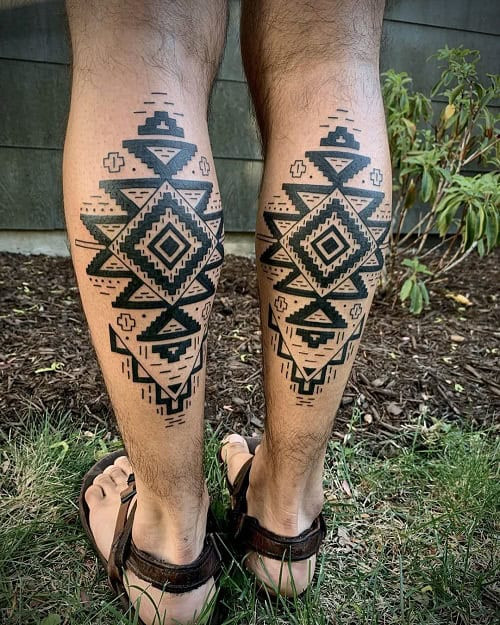 Mexican tribal tattoo on a man's chest, possibly featuring Aztec or Mayan inspired designs.