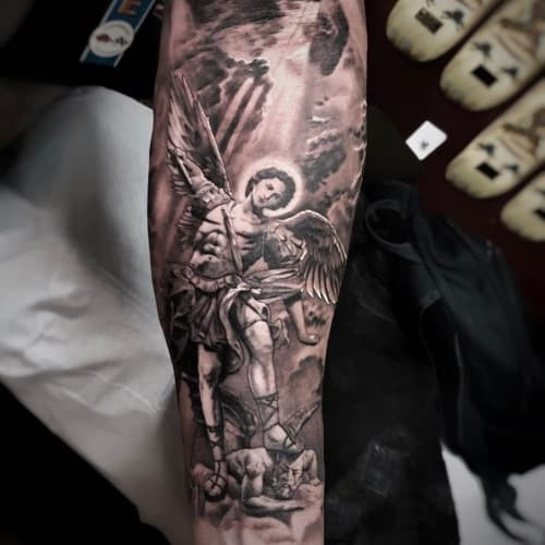 Bold Archangel Michael tattoo with a sword, representing strength, protection, and divine leadership.