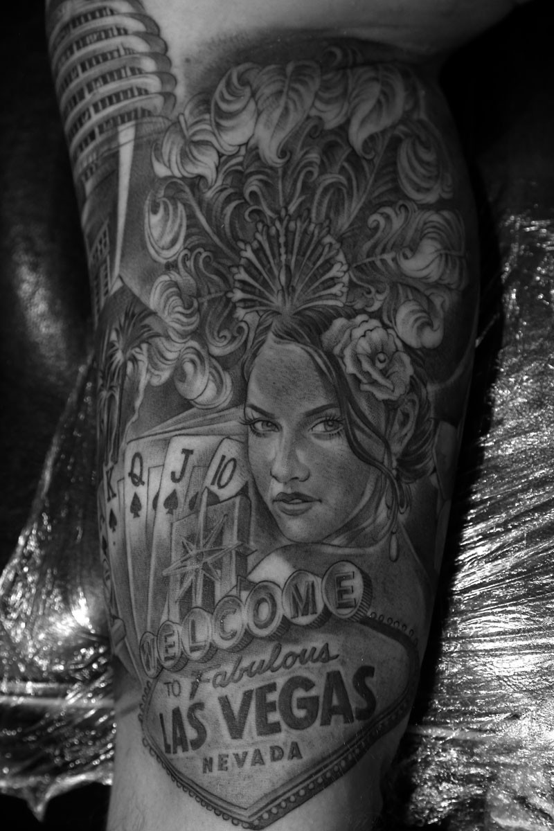 Inner arm sleeve tattoo with showgirl and Las Vegas sign