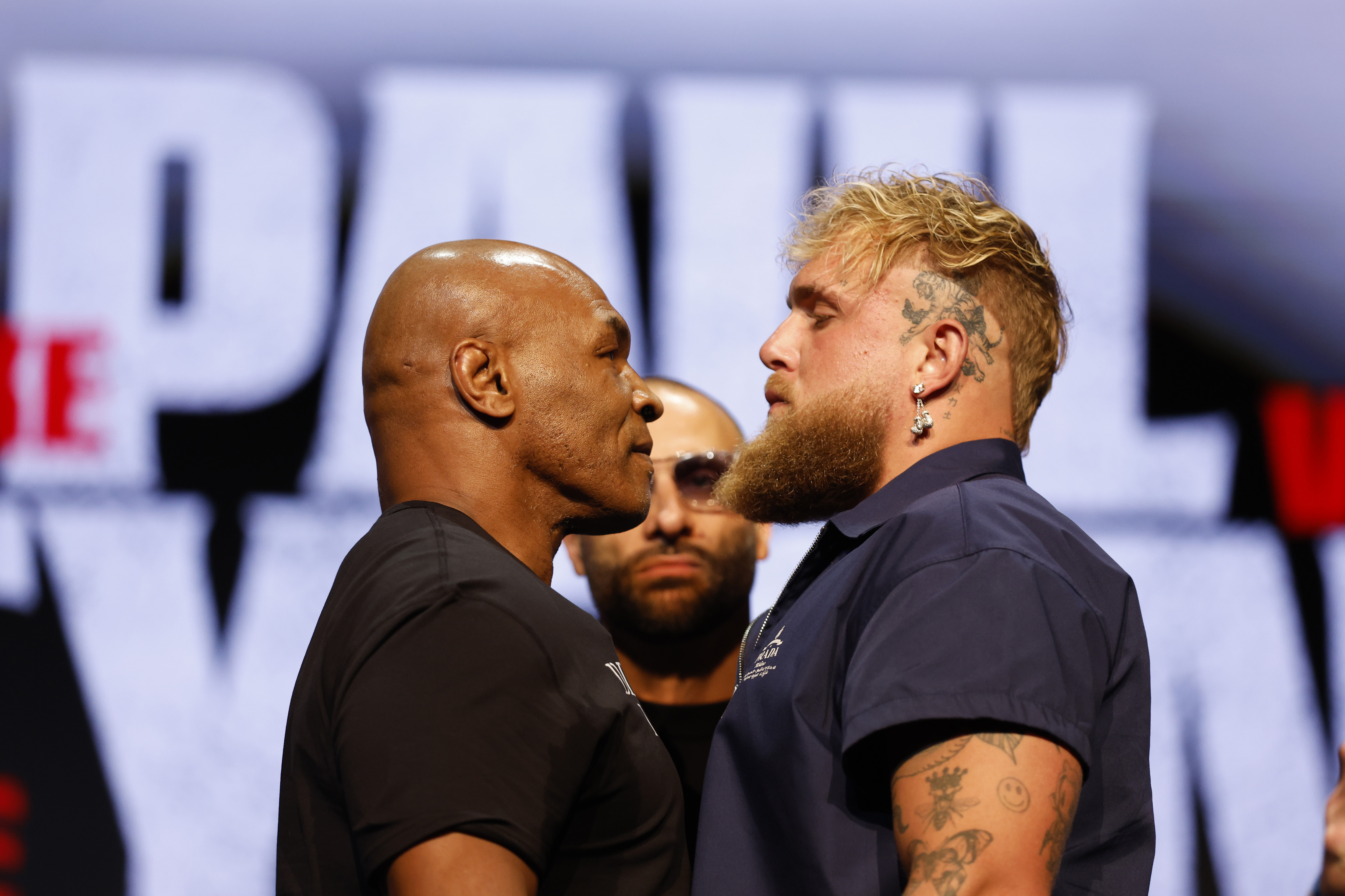 Tyson and Jake Paul staring at each other 