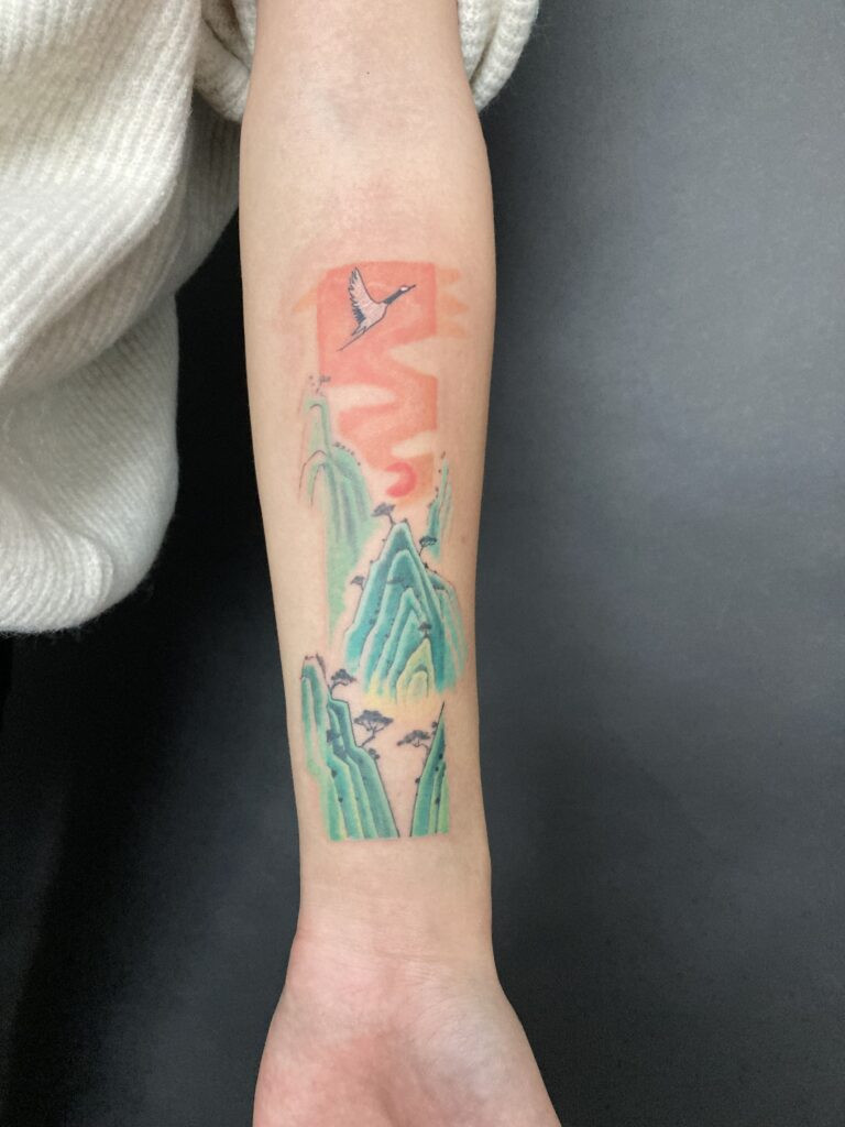 Rectangular landscape tattoo on forearm, demonstrating how the tattoo's portrait orientation complements the vertical space, enhancing aesthetic tattoo fit.