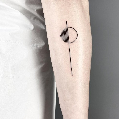 Minimalist geometric line tattoo on a man's forearm