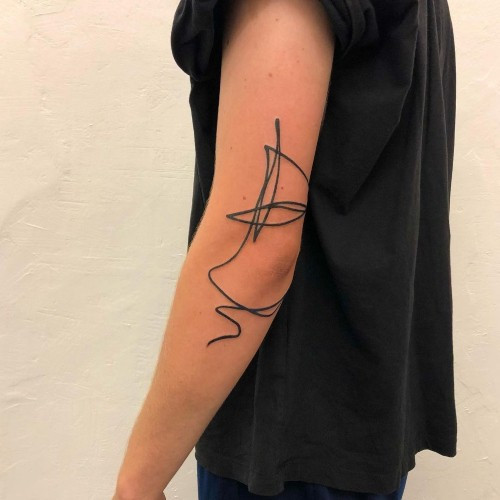 Minimalist mountain outline tattoo on a man's wrist