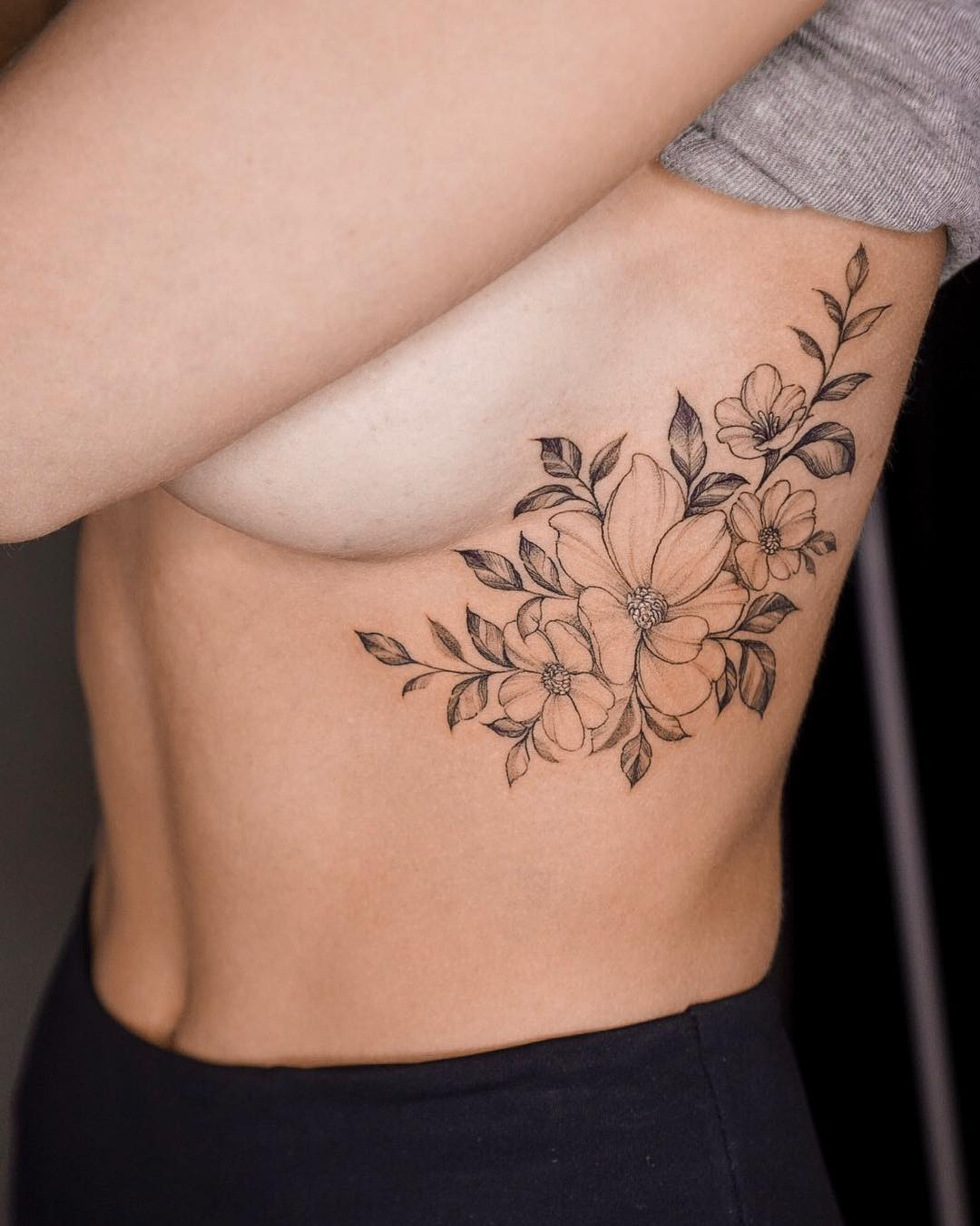 Floral creeper side tattoo, vine and flower design along the side