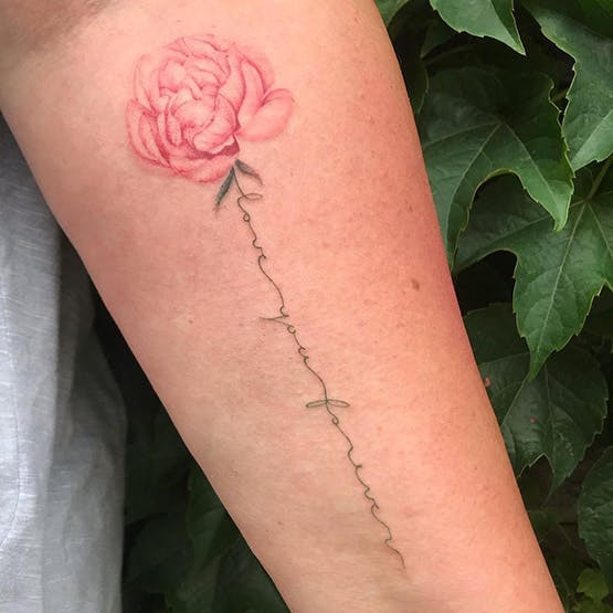 Peony flower miscarriage tattoo with quote on stem.